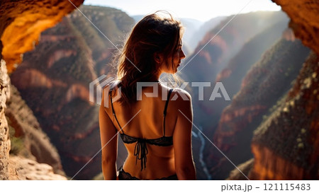 Woman in lingerie back view hiking in a breathtaking canyon adventure spirit happy 121115483