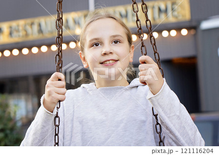 Positive child girl on playground. Kids play outdoor. Positive child girl on playground. Kids play outdoor. 121116204