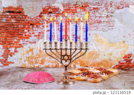 Jewish celebration of Hanukkah, where nine candles in menorah are lit to fill homes with warmth joy Jewish celebration of Hanukkah, where nine candles in menorah are lit to fill homes with warmth joy 121116519
