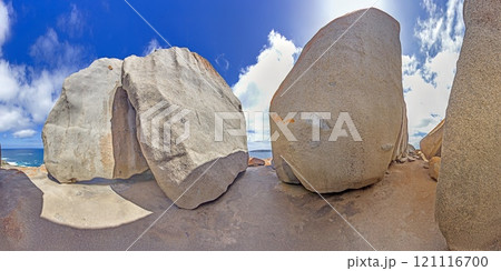 View through remarkable rock formations framing blue ocean under a bright sky during daytime 121116700