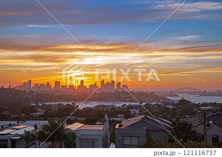 Stunning sunset over Sydney with a view of the skyline and Harbour Bridge from a hilltop Stunning sunset over Sydney with a view of the skyline and Harbour Bridge from a hilltop 121116737