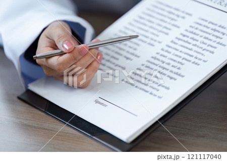 Doctor Advises Patient to Sign Important Medical Documents for Health and Treatment Authorization in a Clinical Setting 121117040