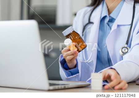 Doctor Recommends Medication via Online Consultation Using Laptop for Modern Healthcare Solutions and Telemedicine Services 121117048