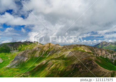 Picturesque Mountain Landscape with Lush Green Hills and Cloudy Sky Kaprun, Austria 121117975