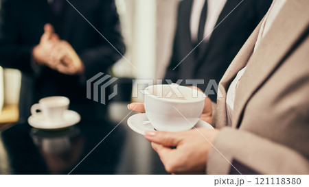 Close-up o professional holding coffee cup, symbolizing connection and communication during a networking event. Close-up o professional holding coffee cup, symbolizing connection and communication during a networking event. 121118380