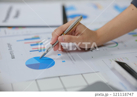 A person is writing on a graph with a pen A person is writing on a graph with a pen 121118747