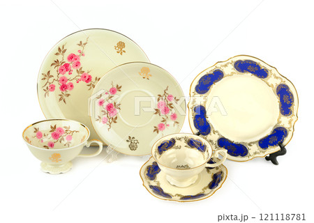 Set of Vintage porcelain cups and saucers isolated on white background. Set of Vintage porcelain cups and saucers isolated on white background. 121118781