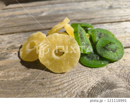 pineapple and kiwi slices on a wooden table. View from above. High quality photos 121118991