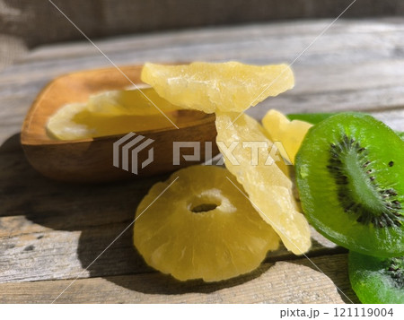 pineapple and kiwi slices on a wooden table. View from above. High quality photos 121119004