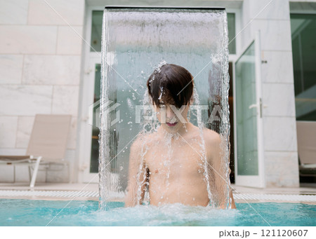 Teen boy enjoying water stream 121120607