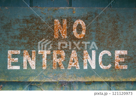 Old inscription NO ENTRANCE on a blue background. Fragment of old dirty sign. 121120973