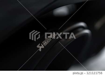 The image shows a detailed view of an Akrapovic exhaust system with a sleek, dark metallic finish, emphasizing its high performance branding. 121121756