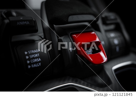 Interior view of a Lamborghini Urus Performante featuring a red start or stop button and driving mode selectors labeled Strada, Sport, Corsa, and Rally. Interior view of a Lamborghini Urus Performante featuring a red start or stop button and driving mode selectors labeled Strada, Sport, Corsa, and Rally. 121121845