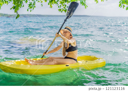 Woman kayaking on Bacalar Lake in Mexico. Adventure tourism in Quintana Roo, outdoor exploration, and water activities concept 121123116