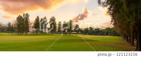 A serene golf course surrounded by trees and bathed in the soft, golden hues of a tranquil sunset, offering a peaceful escape. A serene golf course surrounded by trees and bathed in the soft, golden hues of a tranquil sunset, offering a peaceful escape. 121123216