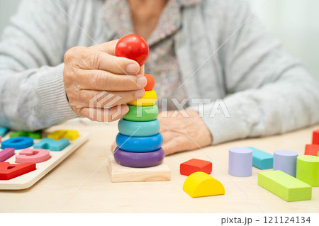 Asian elderly woman playing game. 121124134