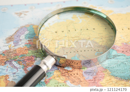 Bangkok, Thailand May 15, 2022 Magnifying glass on world map. Bangkok, Thailand May 15, 2022 Magnifying glass on world map. 121124170