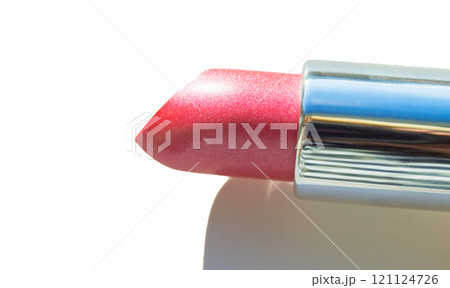 Close-up of a part of a golden tube of lipstick on a white background Close-up of a part of a golden tube of lipstick on a white background 121124726