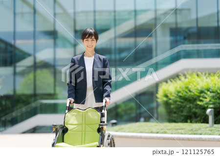 車椅子とスーツ姿の女性 車椅子とスーツ姿の女性 121125765