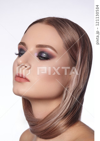Beautiful Woman with an Fashion Hairstyle and Creative Makeup. Beauty face with trendy Make-up 121130584
