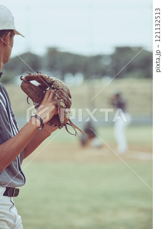 Closeup of a pitcher playing a baseball match. Sports player in action about to throw the ball to a batter. Competitive athlete at a game of baseball in a stadium between two teams 121132513