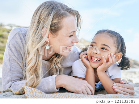 Mature foster mother and her adopted daughter smiling and lying on the beach together. Woman and her cute little girl bonding during a summer day out in the sun. Face to face single parent and child Mature foster mother and her adopted daughter smiling and lying on the beach together. Woman and her cute little girl bonding during a summer day out in the sun. Face to face single parent and child 121132585