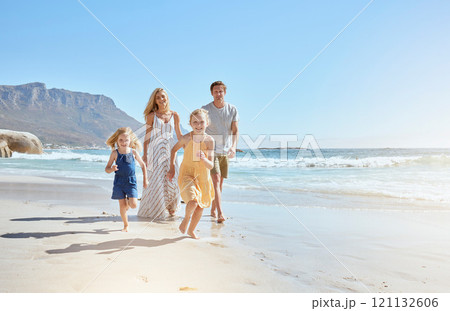 Joyful young family with two children running on the beach and enjoying summer vacation. Two energetic little girls running ahead while their mother and father follow in the background 121132606