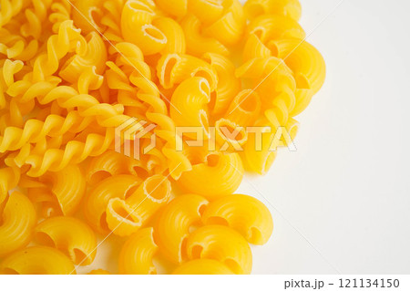 Pasta noodles for cooking Italian food in plastic bag on white background. 121134150