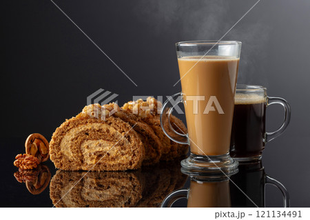Dessert with walnuts and coffee on a black reflective background. 121134491