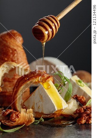 Camembert cream cheese with honey, croissants, and walnuts. 121134496