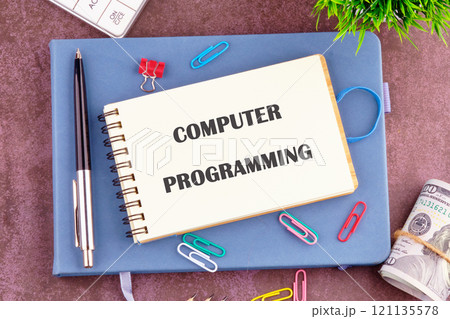 Business concept. Words COMPUTER PROGRAMMING in the notebook, top view. Copy space Business concept. Words COMPUTER PROGRAMMING in the notebook, top view. Copy space 121135578
