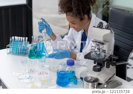 Scientist mixing chemical liquids in the chemistry lab. Researcher working in the chemical laboratory. Scientist mixing chemical liquids in the chemistry lab. Researcher working in the chemical laboratory. 121135738
