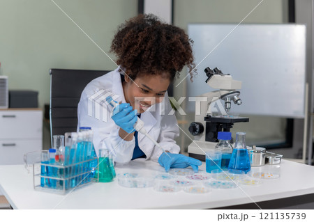 Scientist mixing chemical liquids in the chemistry lab. Researcher working in the chemical laboratory. Scientist mixing chemical liquids in the chemistry lab. Researcher working in the chemical laboratory. 121135739
