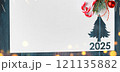 Christmas 2025 background. White paper with fir-tree shape cut for new year 2025 card on wooden table 121135882