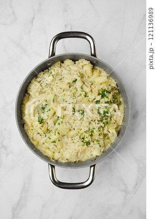 Homemade rice and pear dish garnished with melted blue cheese and herbs, ready for dinner 121136989