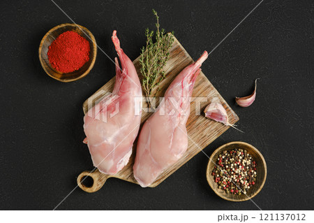 Fresh rabbit meat prepared with spices and herbs for cooking or culinary purposes Fresh rabbit meat prepared with spices and herbs for cooking or culinary purposes 121137012