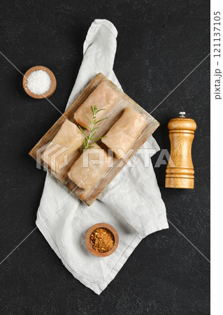 Deliciously wrapped cabbage spring rolls on a wooden board with herbs and spices Deliciously wrapped cabbage spring rolls on a wooden board with herbs and spices 121137105