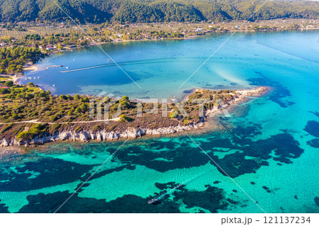 Seascape on a sunny day. Top view of a beautiful bay. Aegean sea texture in Vourvourou, Greece Seascape on a sunny day. Top view of a beautiful bay. Aegean sea texture in Vourvourou, Greece 121137234