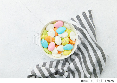 Traditional Easter Portuguese candies. Colorful Sweets in a bowl on grey background 121137670