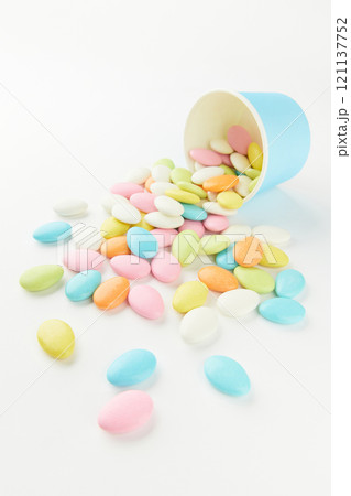 Traditional Easter Portuguese candies. Colorful Sweets in a blue paper cup on a white background Traditional Easter Portuguese candies. Colorful Sweets in a blue paper cup on a white background 121137752