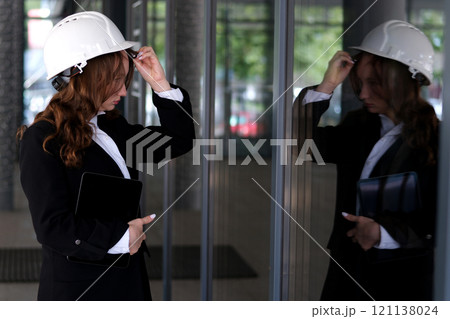 Young woman architect smiling confident standing at street 121138024