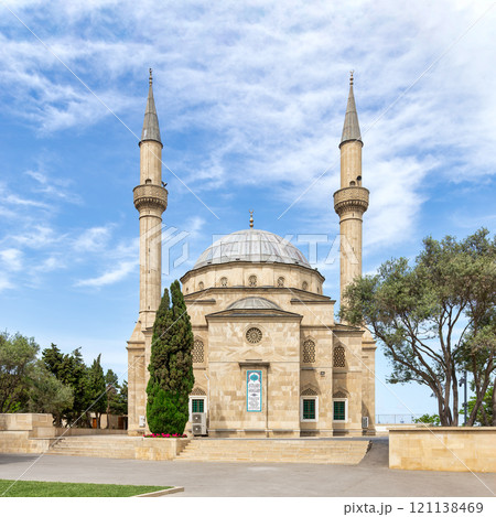 The Shehitler Mosque, a historic mosque with twin minarets in a serene landscape under a cloudy sky in Baku, Azerbaijan The Shehitler Mosque, a historic mosque with twin minarets in a serene landscape under a cloudy sky in Baku, Azerbaijan 121138469