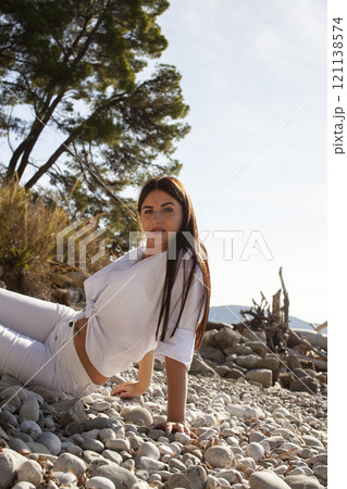 young pretty brunette woman on sea coast, lifestyle people concept close up 121138574