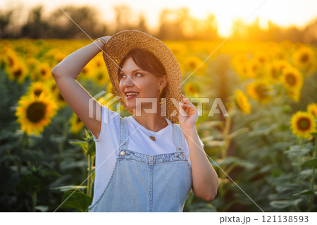 Young Pretty Woman In Straw Hat, Sunflowers Field Posing and Smiling. Summertime 121138593