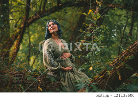 Mother nature cosplay, expecting woman in wild forest. maternity. Beauty female Mother nature cosplay, expecting woman in wild forest. maternity. Beauty female 121138600