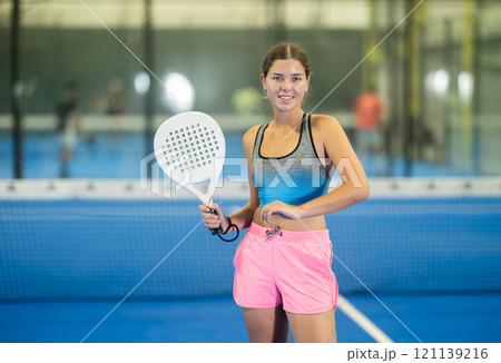 Young woman posing on tennis court Young woman posing on tennis court 121139216