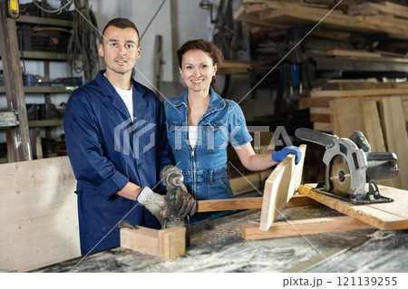 Portrait of male worker and female manager of woodworking enterprise Portrait of male worker and female manager of woodworking enterprise 121139255