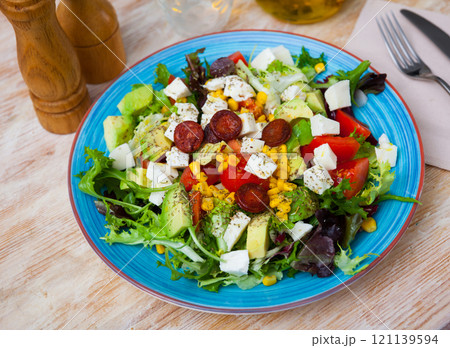 Fresh vegetable salad with mozzarella and sausages Fresh vegetable salad with mozzarella and sausages 121139594