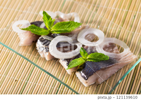 Marinated herring with sliced onion Marinated herring with sliced onion 121139610