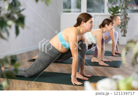 Three women doing fitness in fitness studio 121139717